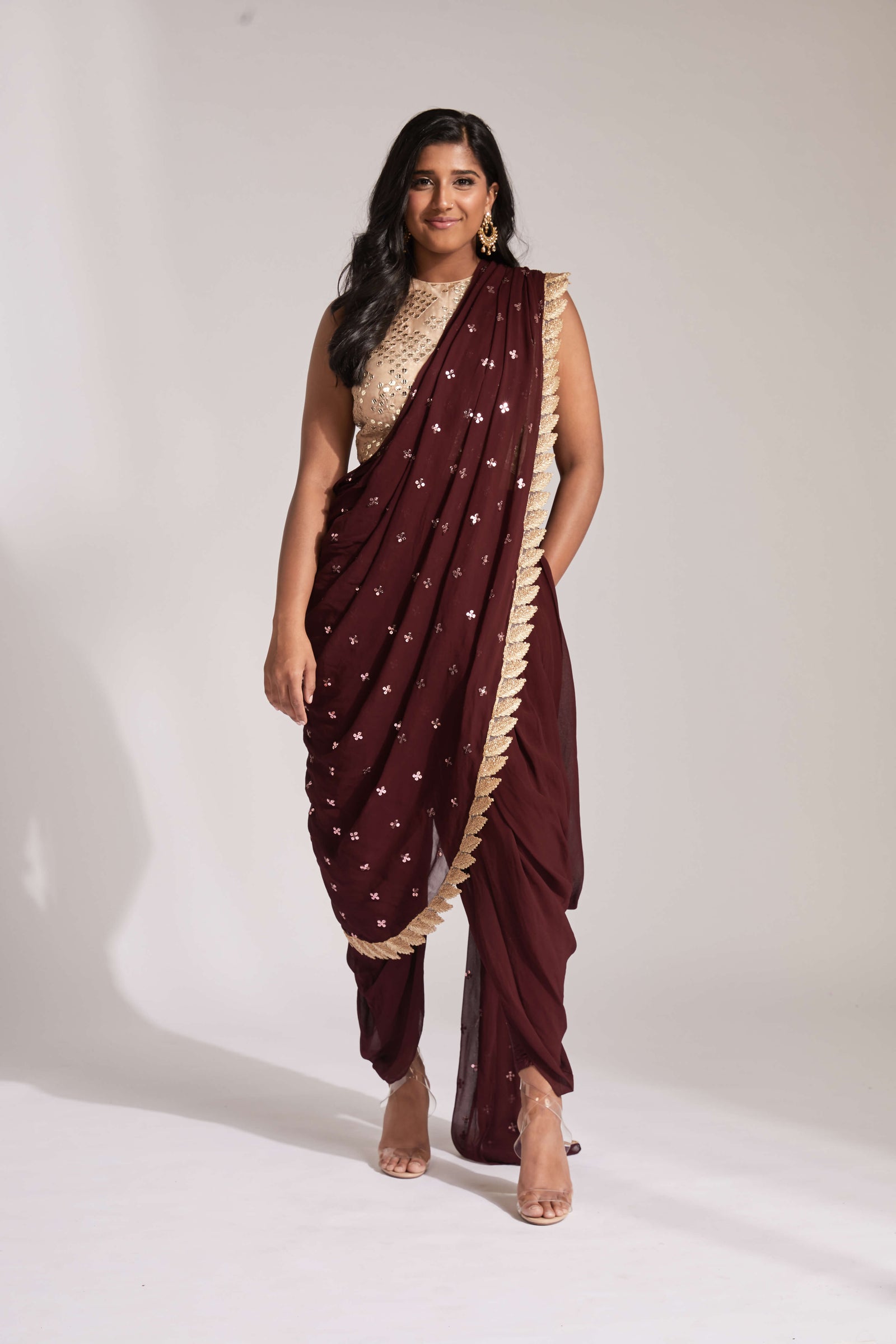 Blue dhoti pant outfit with attached drape and nude mirror work halter-style blouse